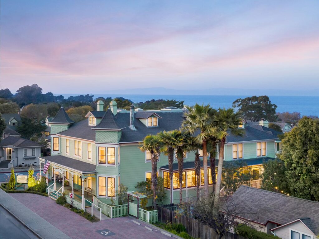 Aerial view of Centrella Hotel at sunset with Monterey Bay in the background.