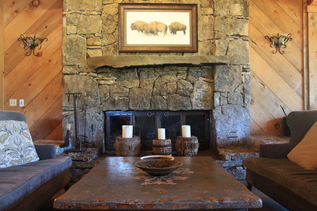 Stoen fireplace with cozy seating on either side.