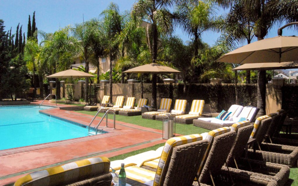 Swimming pool and lounge chairs with umbrellas at the Hollywood Hotel