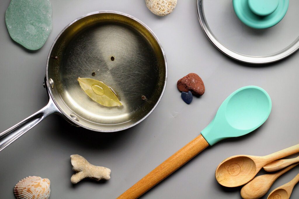 Reduce dry white wine with champagne vinegar, bay leaf, and peppercorns