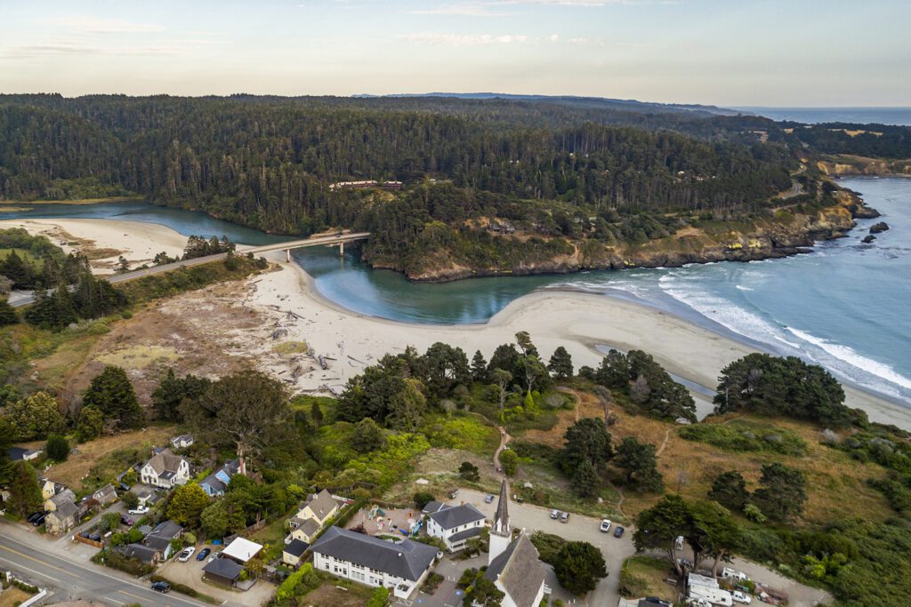 Aerial view of the quaint village of Mendocino, the headlands, Big River Beach, and the river estuary flowing into the ocean.