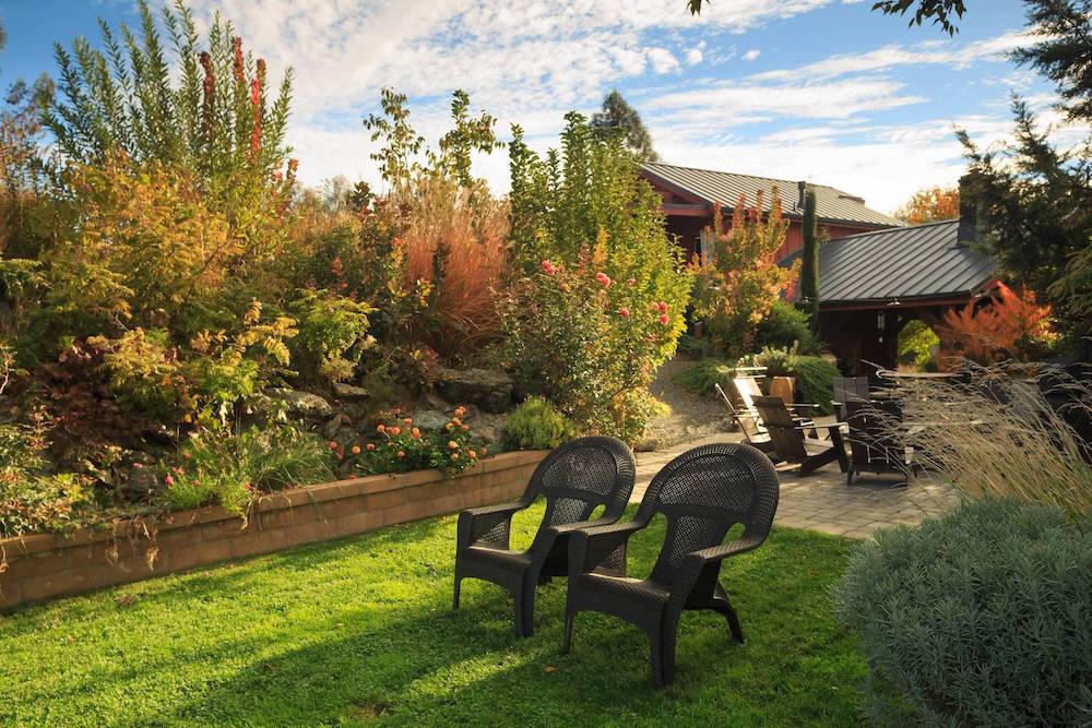 two chairs in a gatden with fall color