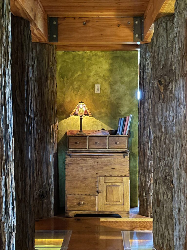 Newport Suite hallway lined with redwood trunks