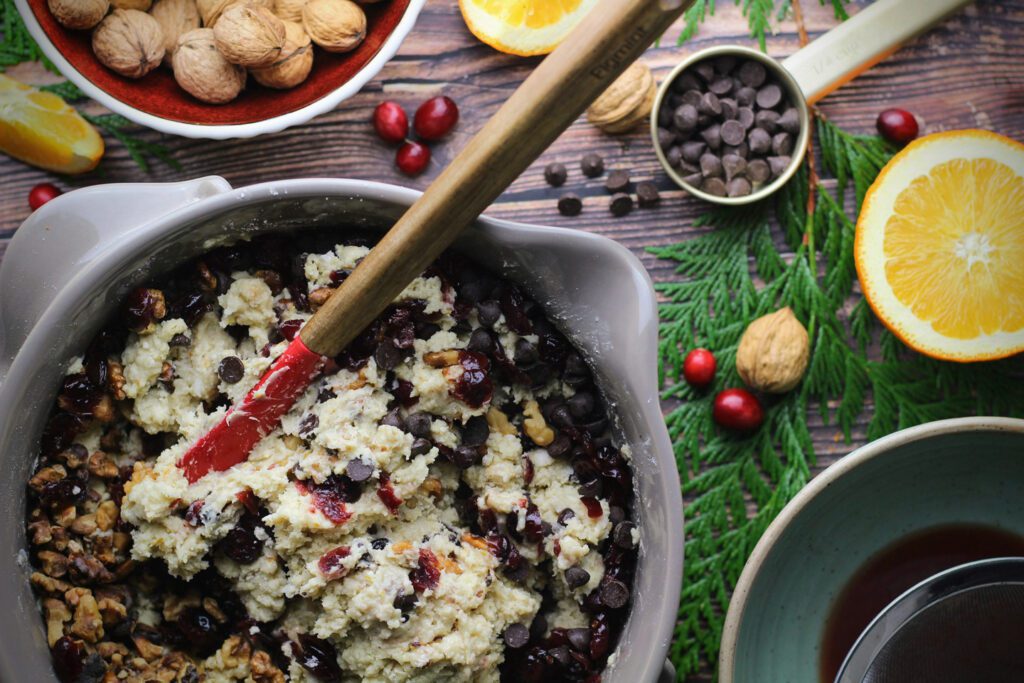 Toss the wet and dry ingredients together to form a dough, then fold in the cranberries, walnuts, and chocolate