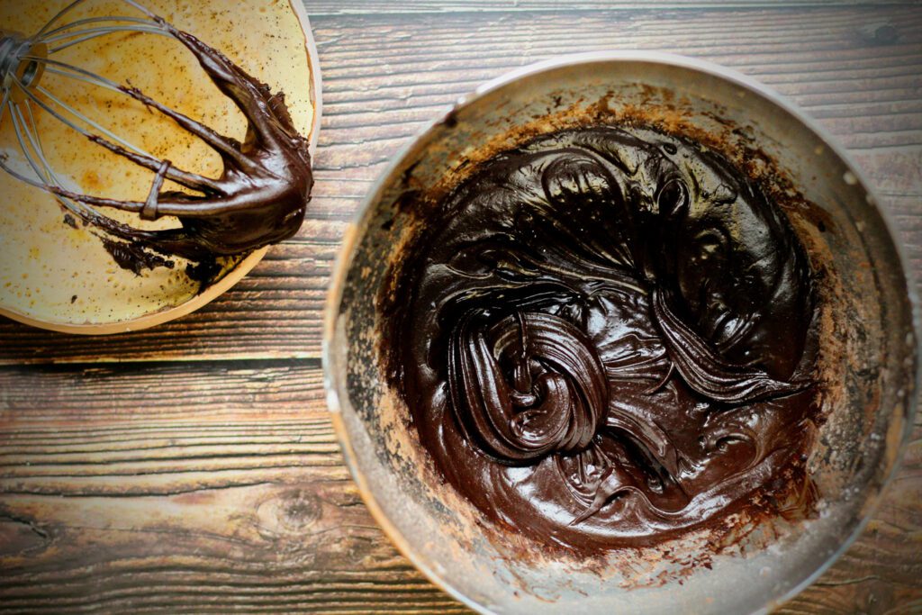 Continue whipping until the egg white mixture thickens.