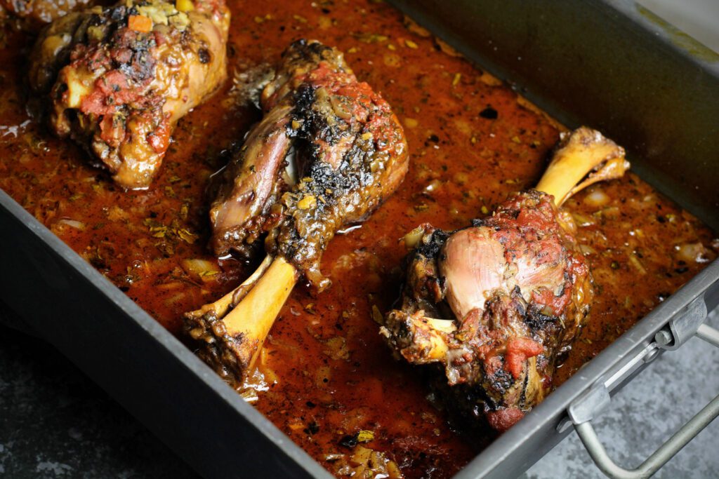 Baked lamb shanks in a roasting pan