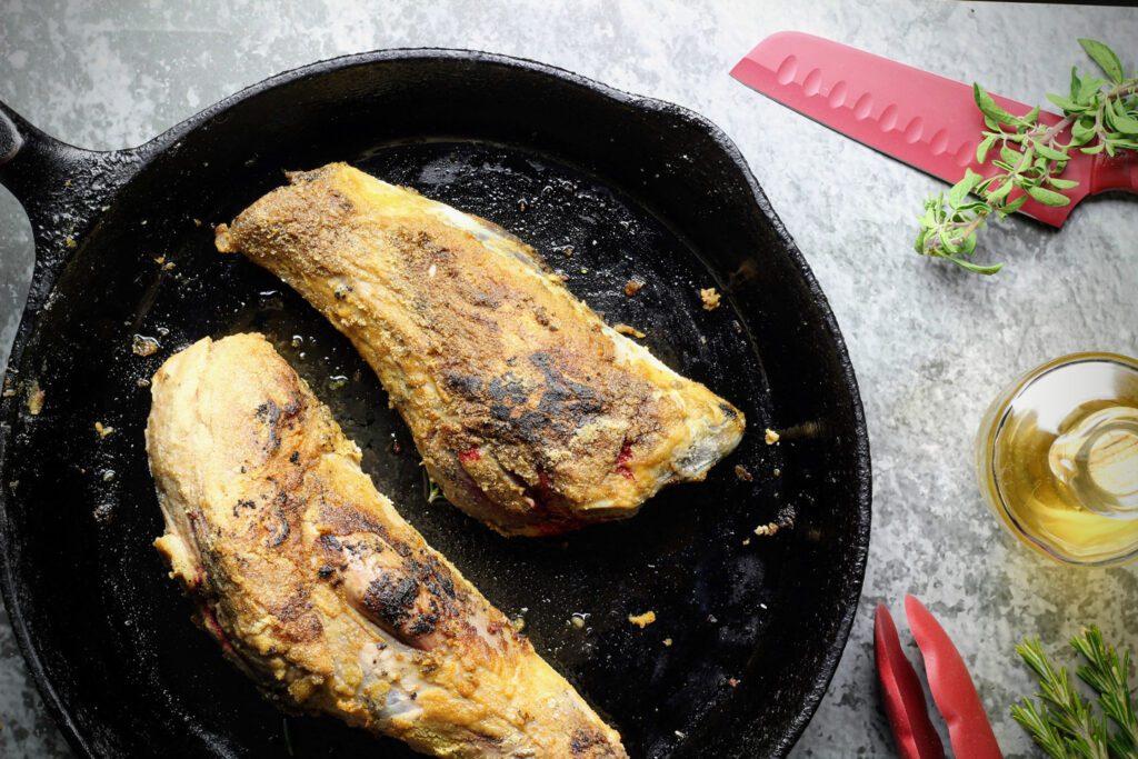 Searing the lamb shanks in a pan