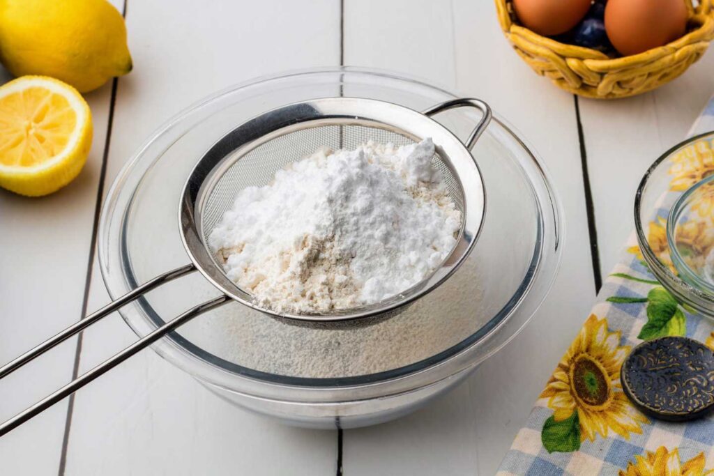 Sifting the dry ingredients for the pancakes into a small bowl