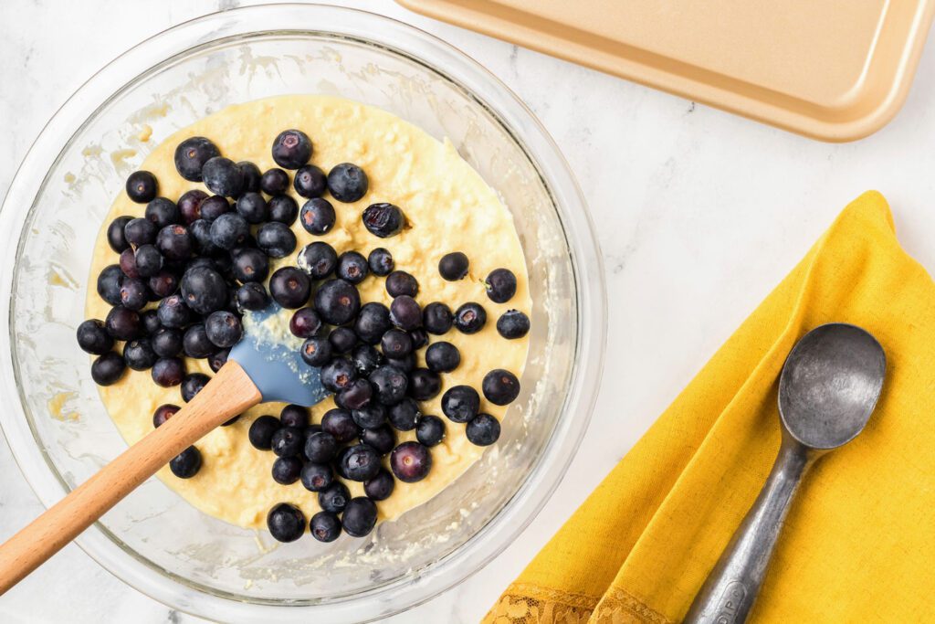 Folding blueberries into the dough