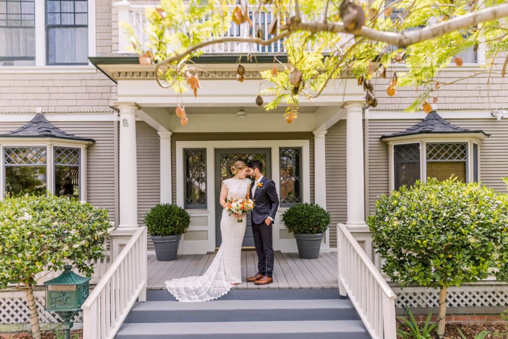 Bride and groom on the front porch of De La VIna Inn