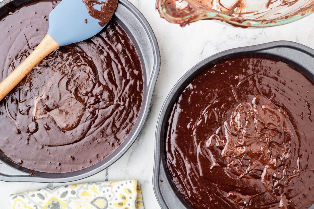 Pouring the cake batter into two baking pans