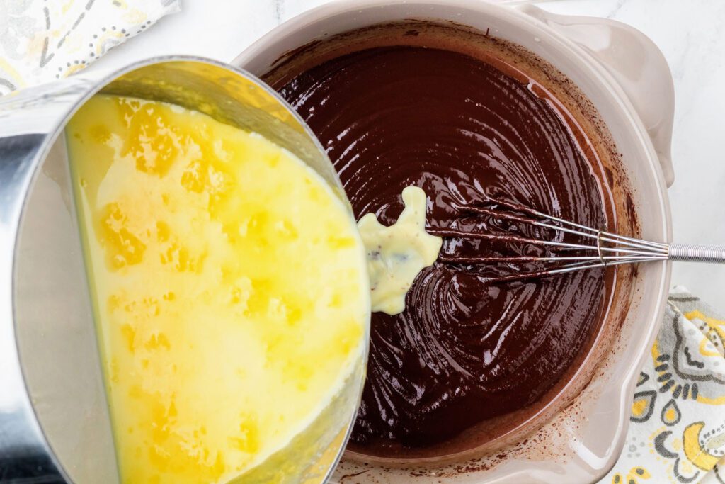 Pouting the cream, glucose syrup and salt into a bowl of melted chocolate