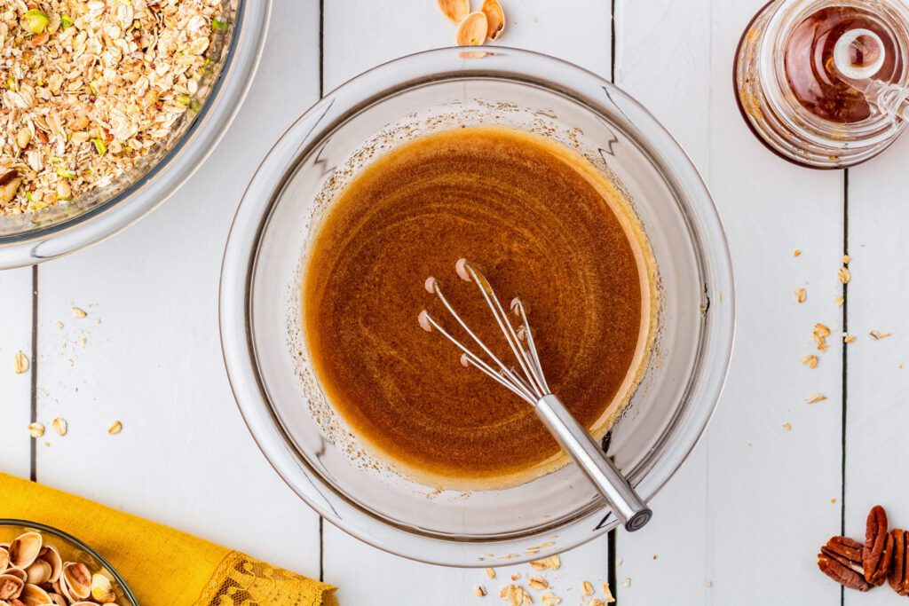 Whisking the wet ingredients in a glass bowl.