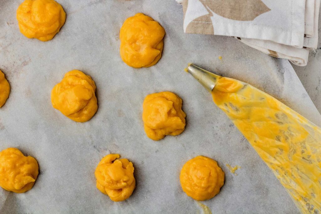 Dough piped onto the sheet pan