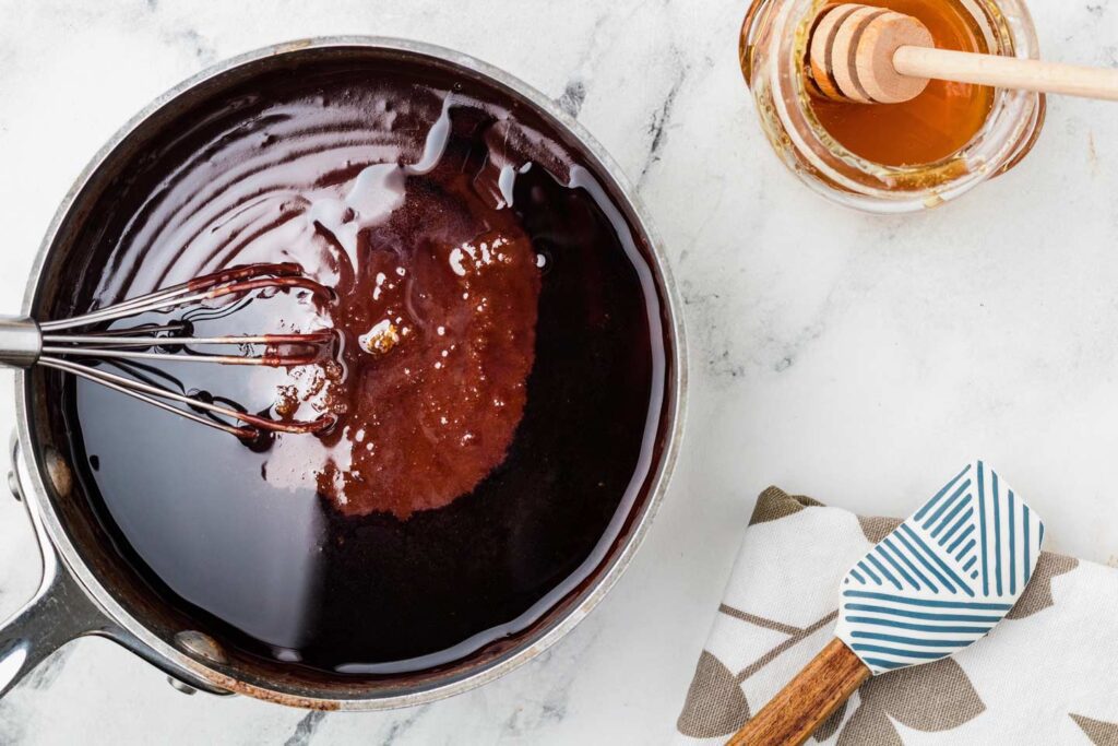 Sitrring honey and espresso into the chocolate sauce