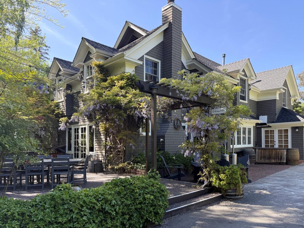 Exterior of Sand Rock Farm with wisteria blooms