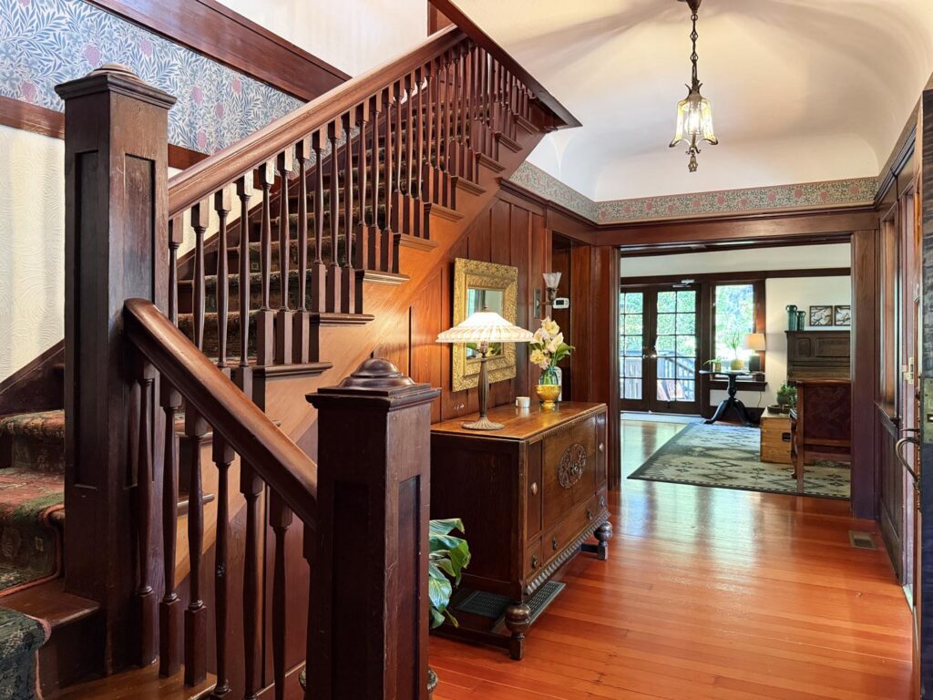 Spindled redwood staircase with paneling.