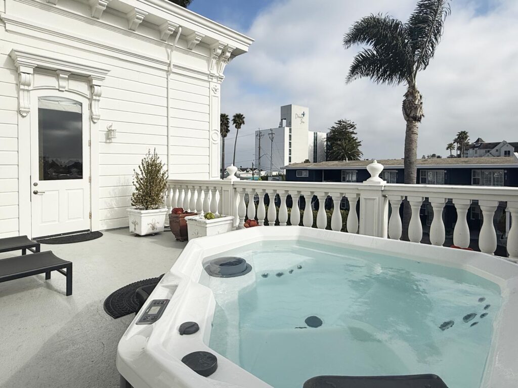 A private deck with a hot tub