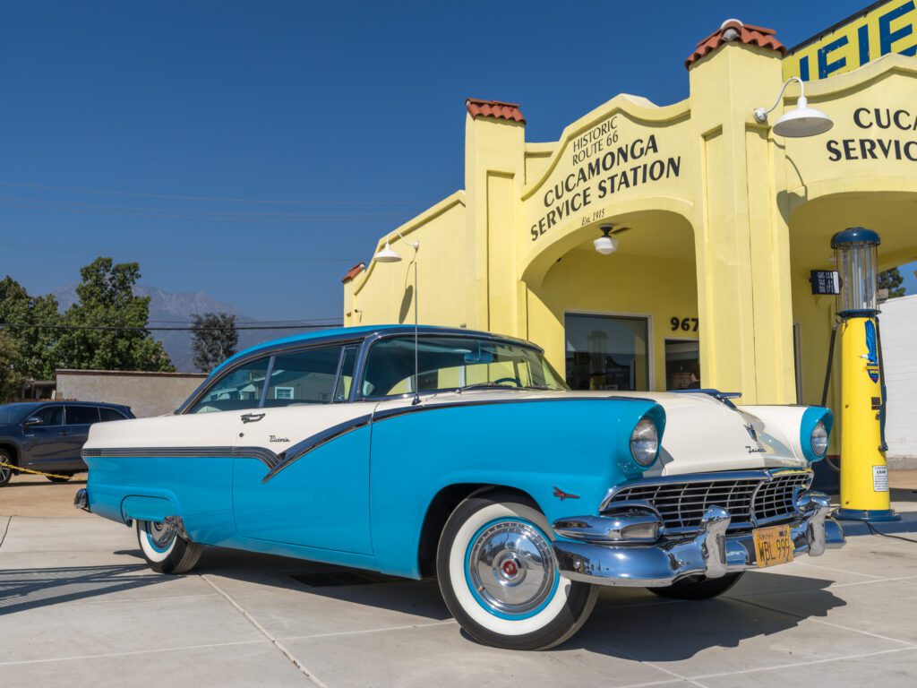 A 1950s Ford Fairlane parked outside a restored vintage service station in Rancho Cucamonga