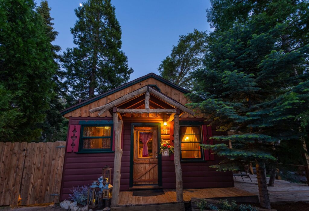 a rustic cabin beneath the pines at dusk
