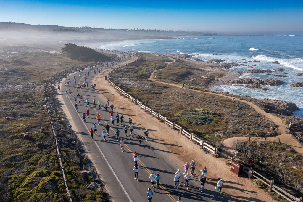 Runners along the shoreline in Pacific Grove for the Monterey Bay Half Marathon