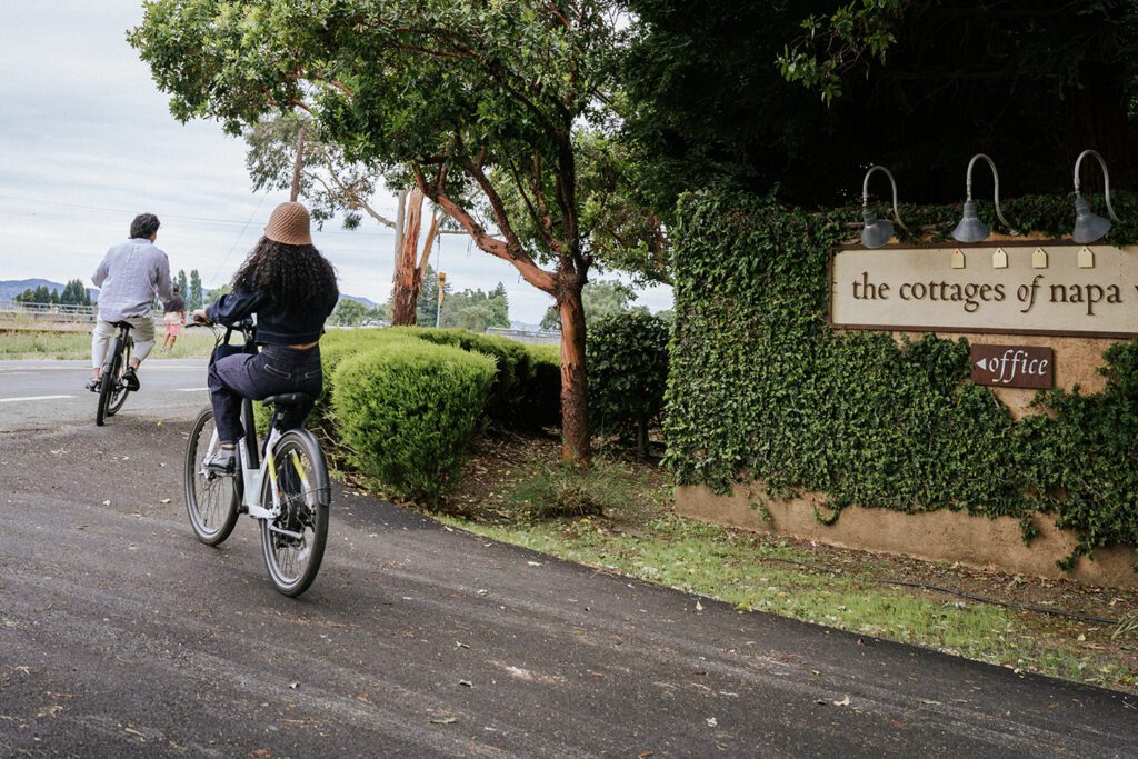 A couple bicycling from The Cottages of Napa Valley